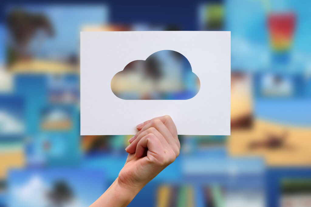 Female hand holding a paper cloud cut out