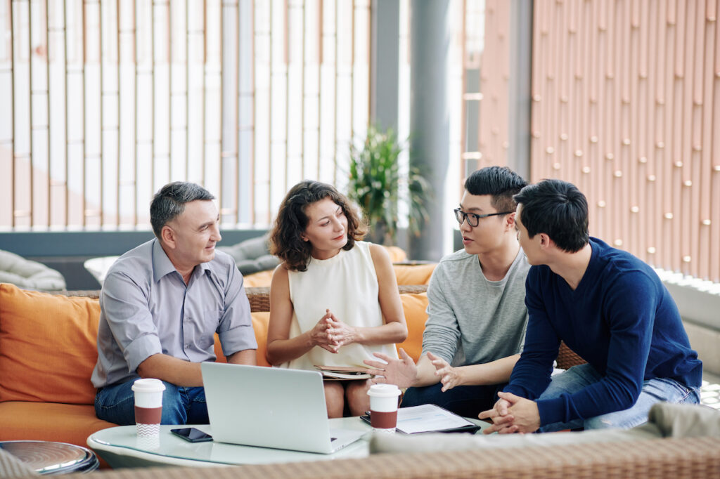 Business people discussing ideas for business continuity plan on couches in the office
