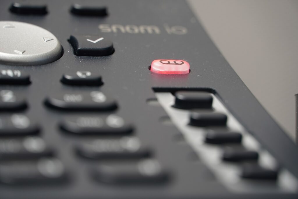 Landline phone with glowing voicemail button