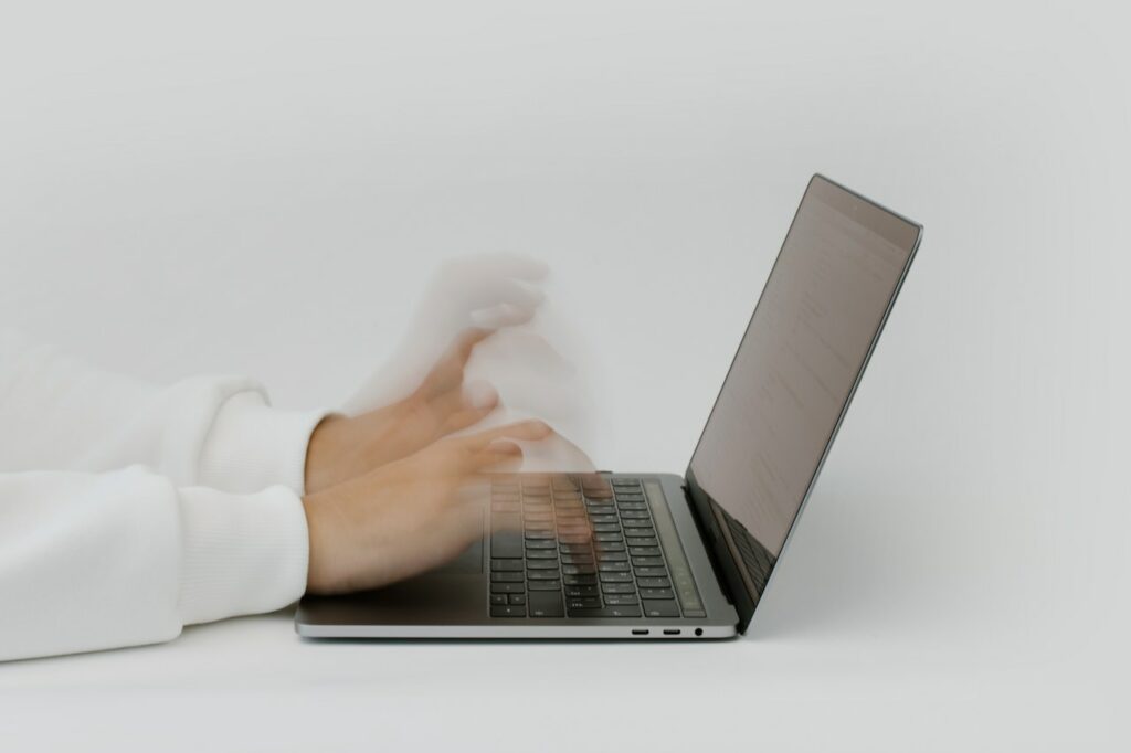 person working at desk and typing fast