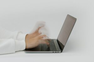 person working at desk and typing fast