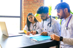 group of medical professionals using medical practice management software