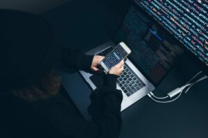 A case of a data leak: Young woman using computer and coding to steal private information.